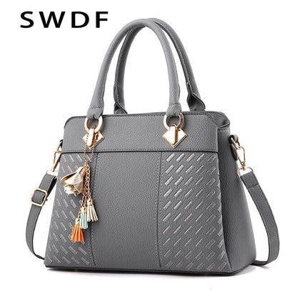 Elegant Gray Handbag with Decorative Tassels